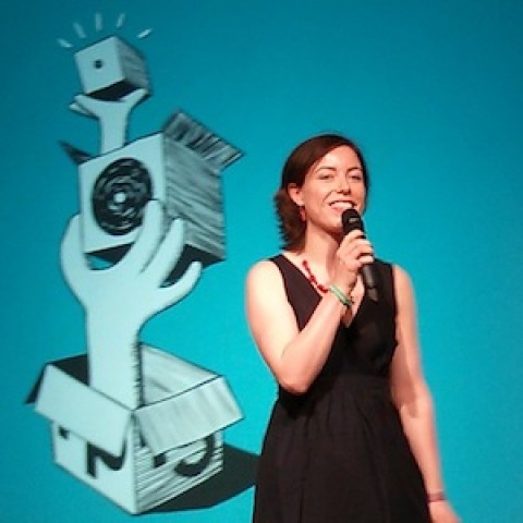 Sandra Mamitzsch dressed in black with a microphone on stage