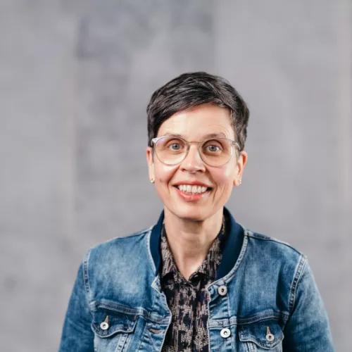 Frau mit Brille und kurzen Haaren