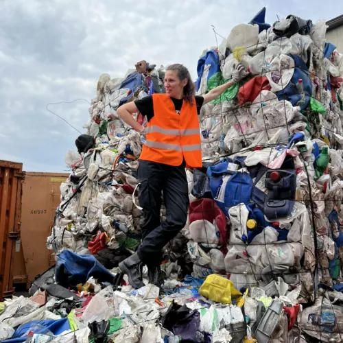 Women standing on sorted waste mountains