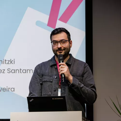 A picture of Alexander Brateanu on stage at FOSS Backstage