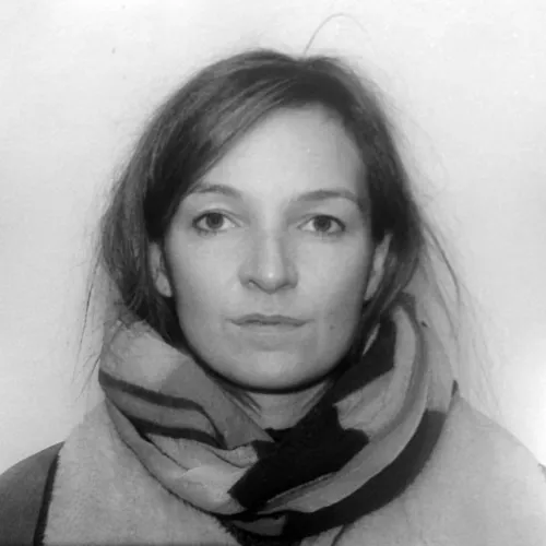 Black and white image of a woman's face looking into the camera.