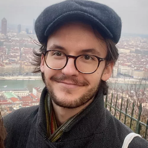 A headshot picture of Quentin Bukold. It is outdoors and he is wearning a cap.